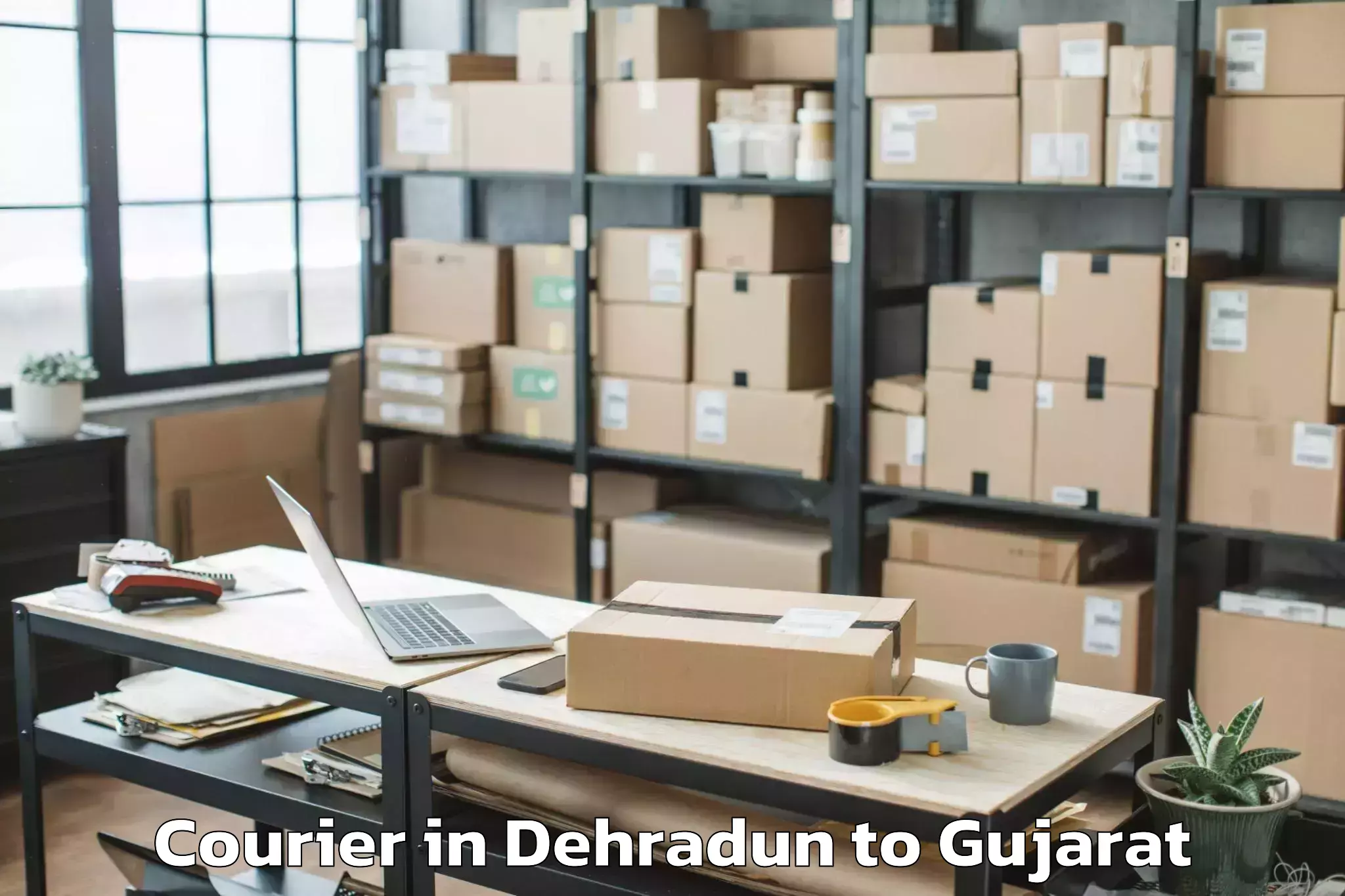 Reliable Dehradun to Karamsad Courier